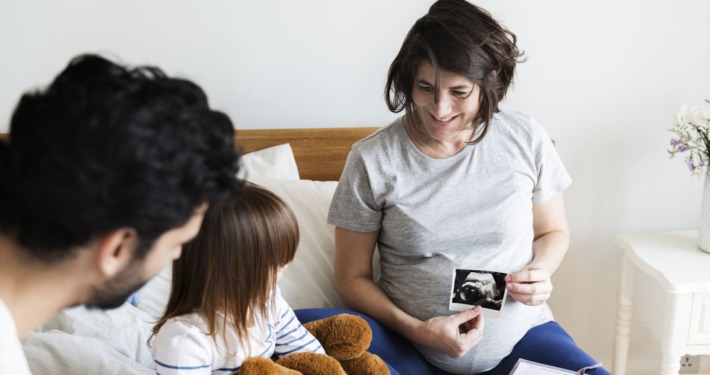 Family view a baby on an ultrasound picture